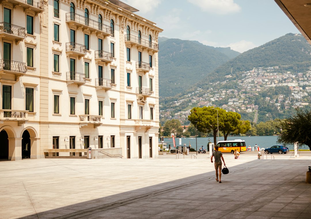 A lakefront palazzo in Lugano, with the wooded slope of Monte Brè behind it
