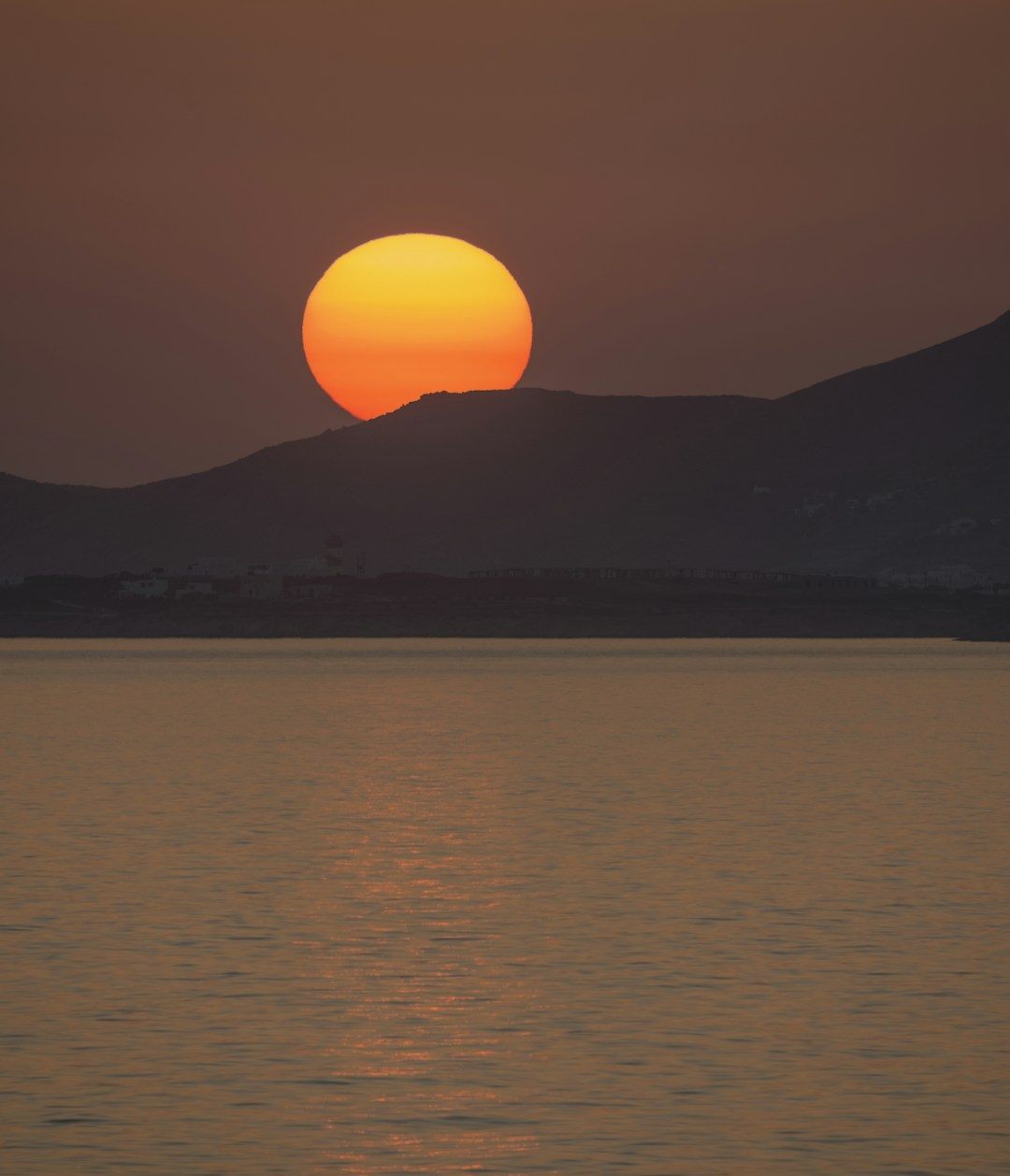 The sun setting over the sea