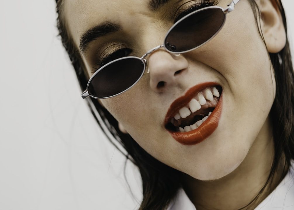 A woman wearing sunglasses, close up