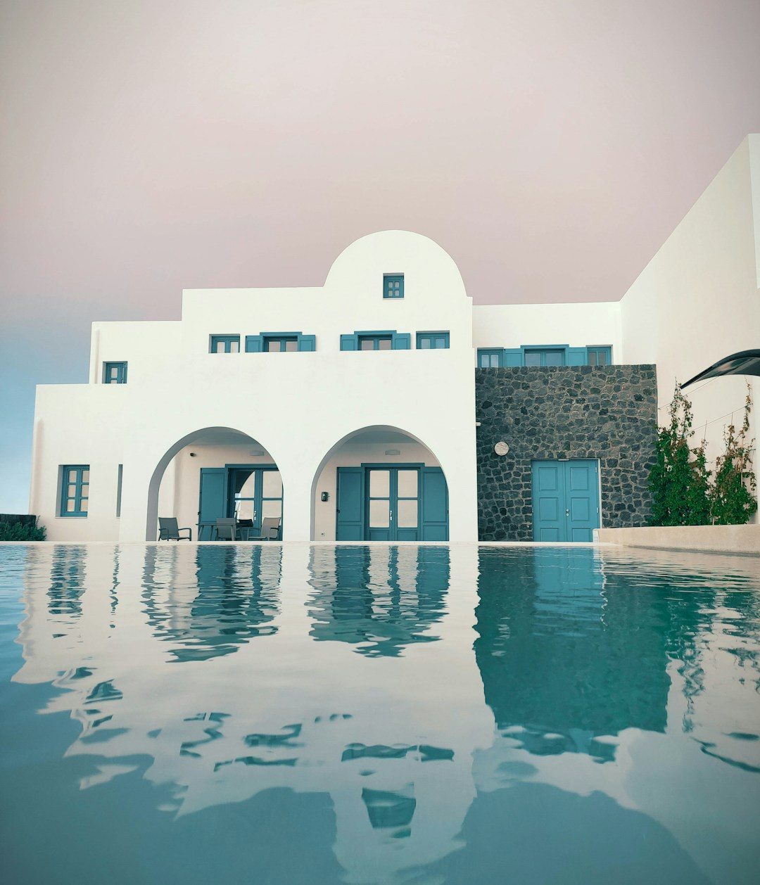 Architectural render of a whitewashed villa with a pool